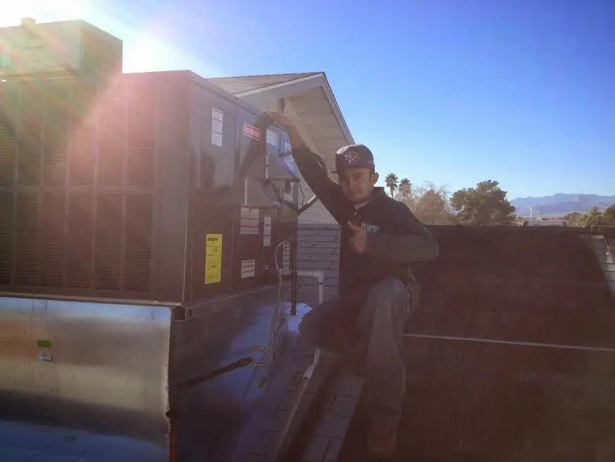 HVAC technician performing HVAC Inspection on a rooftop unit in Westlake Village